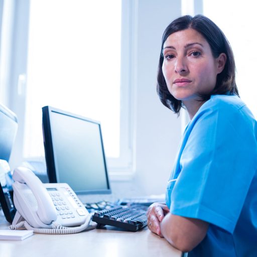 Portrait of doctor sitting in medical office at hospital