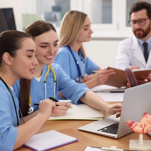 Medical students in uniforms studying at university