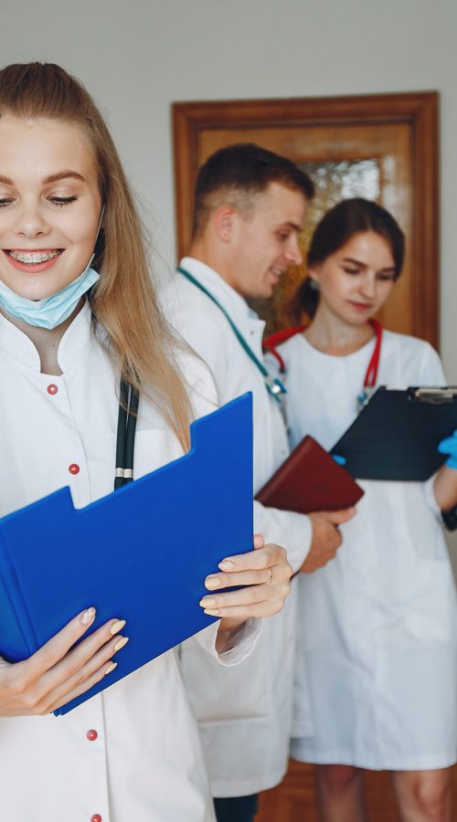 Men and women in hospital gowns study. Students practice medicine. Nurse with a stethoscope.